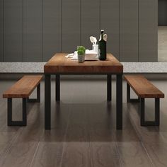 a wooden table with two benches in front of it and bottles on the counter top