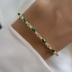 "This stunning emerald and cz bangle bracelet is super trendy and stylish! It's comfortable and lightweight. Looks great stacked or on its own!  - - - D E T A I L S - - - * We use a THICK plating of 14k Gold or Rhodium over 925 Sterling Silver  * Super high-quality & lightweight * Available in 6.25\", 6.75\" or 7\" * Latch Closure * 3mm thick  * Nickel-free & Hypoallergenic  BANGLES ON MODEL----> SOLID BANGLE https://www.etsy.com/listing/1553953045/bangle-bracelet-by-sami-jewels?click_key=f0f5ce3a5a09309ef8860b089ac71977a9c6f94f%3A1553953045&click_sum=b22f030f&ga_search_query=bangle&ref=shop_items_search_1&pro=1&frs=1&sts=1 DIAMOND STUDDED BANGLE: https://www.etsy.com/listing/1553953045/bangle-bracelet-by-sami-jewels Made with 100% Pure Love! ♡ Happy to answer any questions you may have! ? Gold Bracelet Bangle, Bracelet Emerald, The Bangles, Emerald Bracelet, Bracelet Minimalist, Dainty Bracelet, Jewelry Lookbook, Minimalist Bracelet, Bracelet Vintage