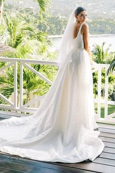 a woman in a wedding dress standing on a porch