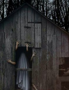 two hands coming out of a barn door with the ghost in it's arms