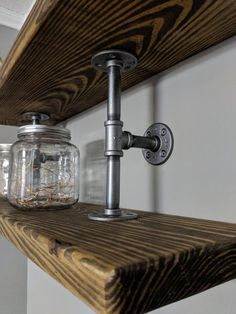 a mason jar is sitting on top of a shelf next to a wall light fixture