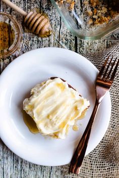 a piece of cake sitting on top of a white plate next to a knife and fork