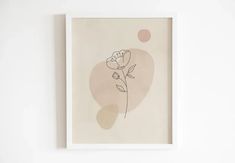 a white framed art piece with a flower on it's left side and a pink dot in the background