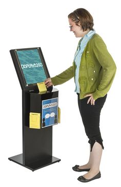 a woman standing in front of a display