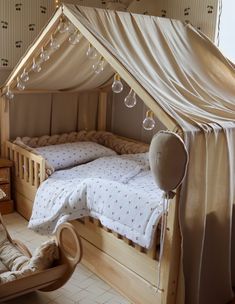 a child's room with two beds, a rocking chair and a baby crib