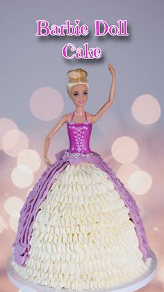 a barbie doll cake with white and purple icing