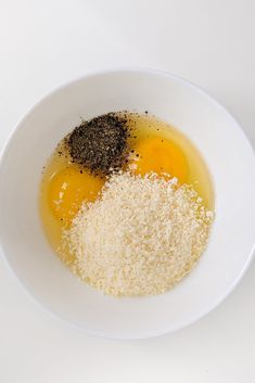 two eggs and spices in a white bowl