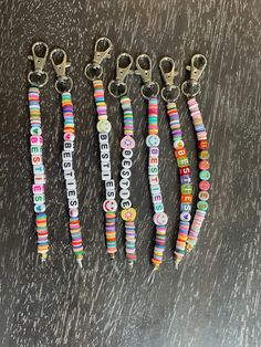 six keychains that have been made out of beads and are on a table