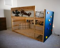 a bunk bed made out of wood with toys on the top shelf and below it