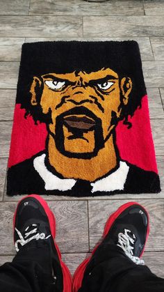 a pair of feet standing in front of a rug with a cartoon character on it