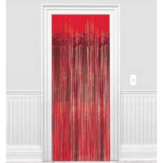 a red door with curtains hanging on it