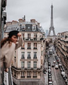 the eiffel tower in paris is seen from an apartment building's balcony