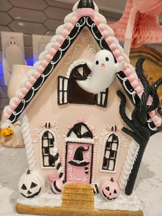 a pink and black house with decorations on it