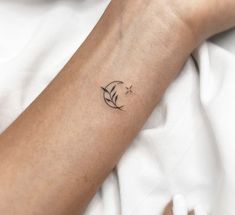 a person's arm with a small tattoo on the left side of their arm