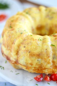 an omelet is sitting on a plate with tomatoes