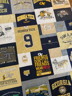 a quilt made to look like the college football team's uniform is displayed on a table