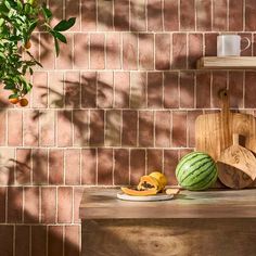 there is a watermelon and other fruits on the table