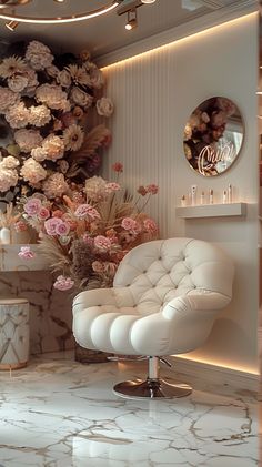 a white chair sitting on top of a marble floor next to a vase filled with flowers