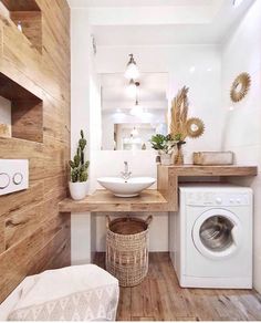 a washer and dryer in a bathroom with wood paneling on the walls