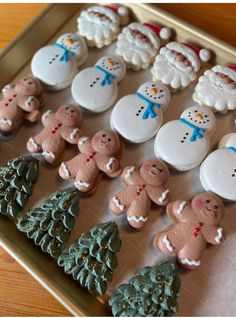 decorated cookies in the shape of christmas trees and snowmen