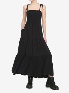 Keep your dark witchy vibes going strong in this black midi dress! Featuring smocked detailing around the bust and a tiered skirt. Comes with adjustable tie shoulder straps and side seam pockets. Pair with a black brimmed hat to complete your look! Girls Maxi Dresses, Brimmed Hat, All Black Looks, Goth Dress, Tiered Midi Dress, Witchy Vibes, Pinterest Outfits, Black Midi, Smocked Dress