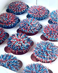 red, white and blue cupcakes with sprinkles in a box