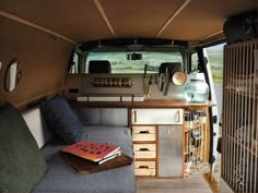 the interior of an rv with lots of storage and furniture in it's back