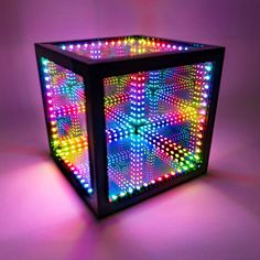 an illuminated cube sitting on top of a table