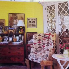 a living room with yellow walls and furniture