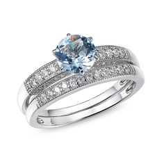 a blue topazte and diamond ring with matching bands on the band, set in 18k white gold