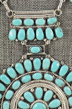 This intricately detailed, turquoise and sterling silver necklace was made by Navajo silversmith Jesse Williams. The back is signed JW and stamped sterling.Necklace: 18"Length: 4 1/4"Width: 3"Free shipping on all orders! We ship with USPS and always include tracking. All orders ship within a day of payment.Returns are accepted up to 30 days after you receive your order. Just send us a message. Our shop offers cash back or store credit. The item must be returned in new condition. Traditional Turquoise Necklace With Concho, Traditional Silver Turquoise Necklace With Concho, Traditional Turquoise Concho Necklace, Traditional Silver Turquoise Concho Necklace, Southwestern Sterling Silver Turquoise Necklace With Large Pendant, Southwestern Silver Turquoise Inlay Necklace, Adjustable Southwestern Turquoise Necklace Hand-strung, Jesse Williams, Sterling Necklace