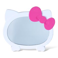 a white hello kitty mirror with a pink bow on it's head and ears