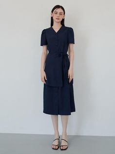 Soft and drapery, this dress features V-neckline and voluminous short sleeves. It is accentuated with detachable layered waist panel for a cute, trendy feel. - Rayon and nylon blend fabric- Airy and crisp texture throughout- A-line hem design- Strap button fastenings through front- Refined and feminine mood Chic Navy Short Sleeve Dress, Elegant Navy Short Sleeve Midi Dress, Navy Short Sleeve Work Dress, Layer Dress, Jumpsuit Dress, A Line, Dress Outfits, Jumpsuit, Short Sleeves