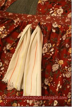 two white towels folded on top of a red blanket