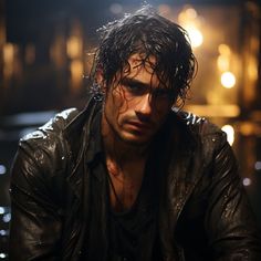 a man with wet hair sitting down in the dark