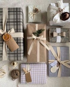 presents wrapped in brown paper and tied with twine on carpeted floor next to orange slice