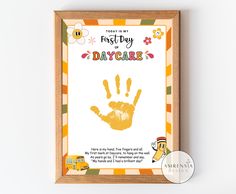 a hand print with the words trust my first day care written on it in front of a wooden frame