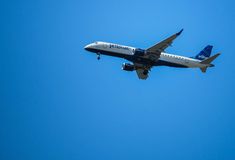 an airplane is flying in the sky on a clear day with blue skies behind it