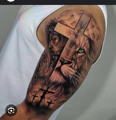 a man with a lion and cross tattoo on his arm