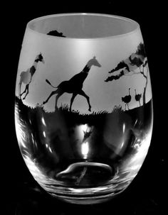 a black and white photo of a wine glass with a giraffe on it