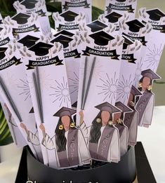 graduation card holders are arranged in a hat and gown design with congratulations written on them