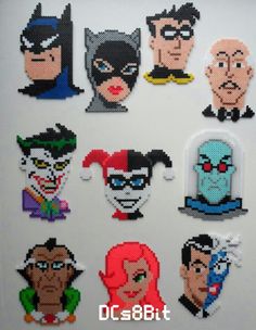 an assortment of pixelated characters are displayed on a white surface with the words dc comics written below them