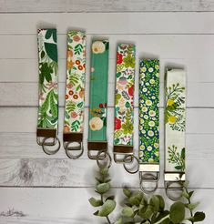 four key fobs are lined up next to each other with flowers on them