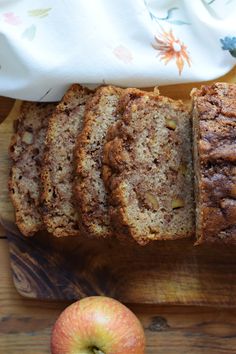 slices of banana bread on a cutting board next to an apple