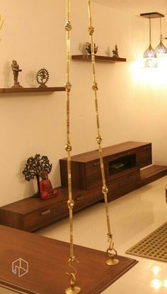 a living room filled with lots of furniture and gold chains hanging from the ceiling above it