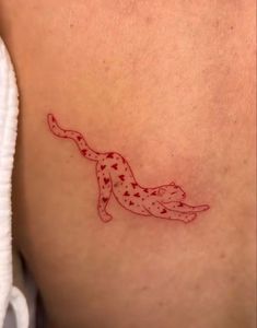 a small tattoo on the back of a woman's stomach, depicting a cheetah