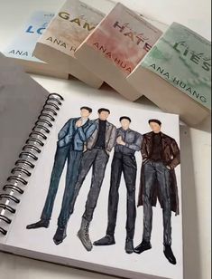 an open notebook with three men's clothes on it next to stacks of bank notes