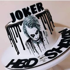 the joker cake is decorated with black and white icing