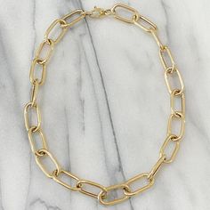 This Italian handcrafted chain link necklace is completely composed of 14K solid gold and is uniquely made with a semi-hollow interior for comfortable everyday wear that will not dent. NOTE: This item is available in longer or shorter length options. Kindly email us for pricing and details. Total Length: available in your choice of 14, 16, 18, 20, 22, 24, 26 or 30 inches Total Gram Weight: 18" length comes out to approximately 33.8 grams of 14K solid gold Link Dimensions: approximately 14mm (W) Luxury Oval Link Gold-tone Chain Necklace, Gold-tone Oval Link Paperclip Chain Necklace, Gold-tone Oval Link Necklace, 14k Gold-filled Oval Link Necklaces, Gold-tone Solid Link Chain Necklace, Sweetheart Bridal, Gold Link, Jewellery Designer, Layering Necklace