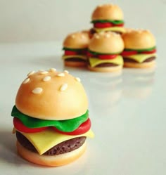 miniature hamburgers are sitting next to each other